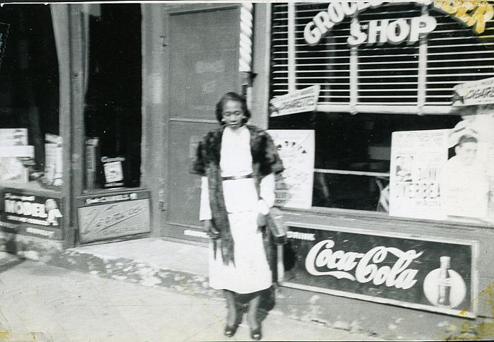 Mrs. Katie Groce in Front of the Barber Shop