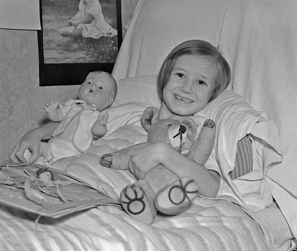 A Sick Child Receives Toys for Christmas